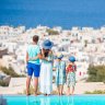 Family of four on european vacation on the edge of pool One time use for Traveller only
Credit: Getty
For family travel sheriden rhodes