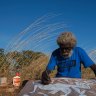 John Mawurndjul, Australian contemporary Indigenous artist working on a bark painting, 