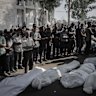 Palestinians pray beside the bodies of those killed during an Israeli airstrike at the Al-Shifa hospital in Gaza City, on Wednesday.