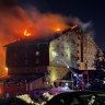 Firefighters work to extinguish a fire in a hotel at a ski resort of Kartalkaya in Bolu province, in northwest Turkey, Tuesday, Jan. 21, 2025. (IHA via AP)