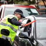  Police check cars for permits at a checkpoint in Coolangatta. 