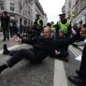 Extinction Rebellion activists are removed by City of London Police after they blocked the road during the Lord Mayor’s Show in London in 2021.