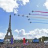 French Elite acrobatic team Patrouille de France flyes over the Eiffel Tower during the Olympic Games handover from Tokyo to Paris in 2021.