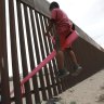 Seesaws straddle the Mexico border, and smiles shine through