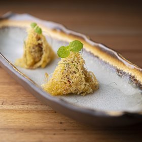 Chicken, lemongrass and coriander in egg net parcels.
