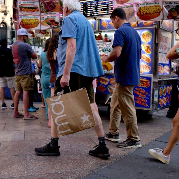 A pedestrian carries a Macy’s Inc. branded shopping bag in New York on Tuesday.
