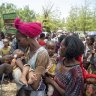 UNICEF nutrition specialist Joseph Senesie (left) screens a child for malnutrition in Adikeh, in the Wajirat district of the Tigray region of northern Ethiopia in 2021.