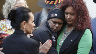NSW MP Linda Burney, left, and federal Senator Malarndirri McCarthy comfort domestic violence victims' advocate Shirleen Campbell from the  Tangentyere Women's Family Safety Group in Alice Springs.