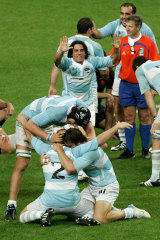 Agustin Pichot, rear center, reacts as Arocena, foreground center, Patricio Albacete, left, and Juan Martin Hernandez embrace each other, after Argentina defeated France 17-12 in the 2007 Rugby World Cup.