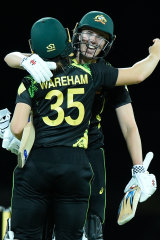 Tahlia McGrath and Georgia Wareham celebrate victory.