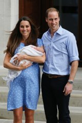 Prince William and Kate, Duchess of Cambridge pose with the Prince George outside St. Mary's Hospital.