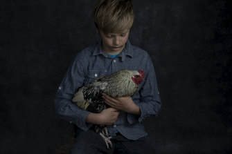 Tom holding one of his prized chickens. 