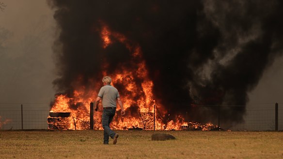 Orangeville residents defend their property as bushfire approaches on Friday.
