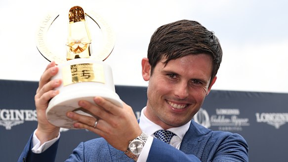 Golden boy: James Cummings holds the Slipper trophy.