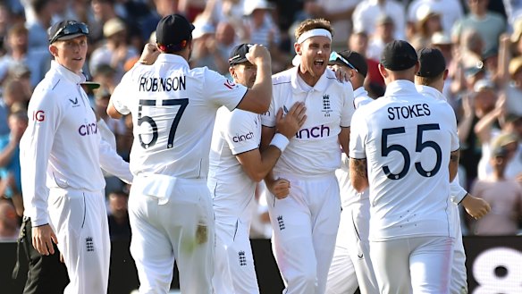 Stuart Broad, centre, celebrates after taking the wicket of Steven Smith during day four of the first Ashes Test cricket match, at Edgbaston, Birmingham.