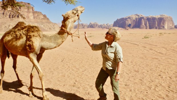 Michele Cotton with a camel in Jordan.