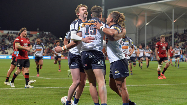 Tom Banks is congratulated by teammates after scoring against the hosts.