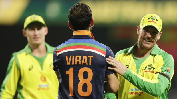 Virat Kohli congratulates Aaron Finch after Australia's victory. 