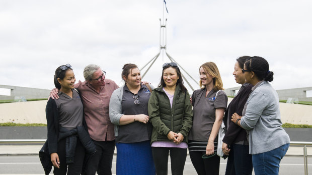 Nipperville Early Childhood Centre workers attended the rally to support their colleague Jangchu Wangchuk (centre). From left: Helen Fabian Kelly, Di Hunt, Cassandra Rijven, Mrs Wangchuk, Kat Darlington, Helena Qian, and Lemlem Bahiru.