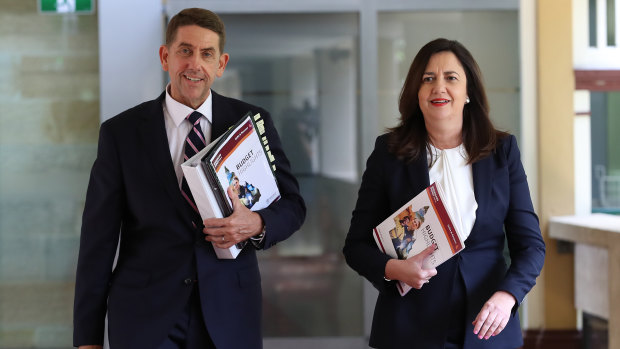 Treasurer Cameron Dick and Premier Annastacia Palaszczuk arrive with the 2020-21 budget papers.