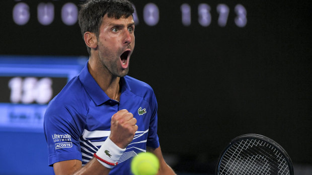 Belligerent: Novak Djokovic wins a key point as he steamrolls Rafael Nadal on centre court.