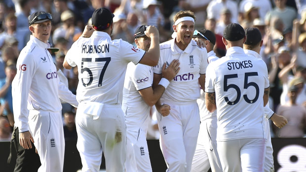 Stuart Broad, centre, celebrates after taking the wicket of Steven Smith during day four of the first Ashes Test cricket match, at Edgbaston, Birmingham.