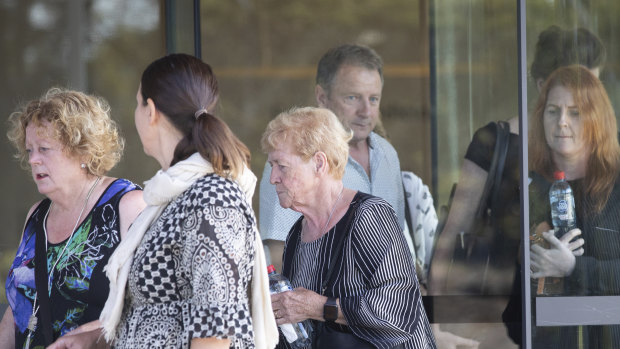 Mr Gore's wife, Angela (middle), and other family members at the NSW Coroners Court in Lidcombe on Monday.