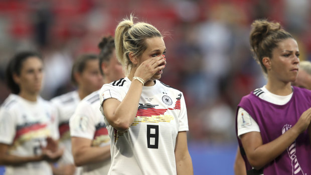 The disappointed Germans leave the field after the loss.