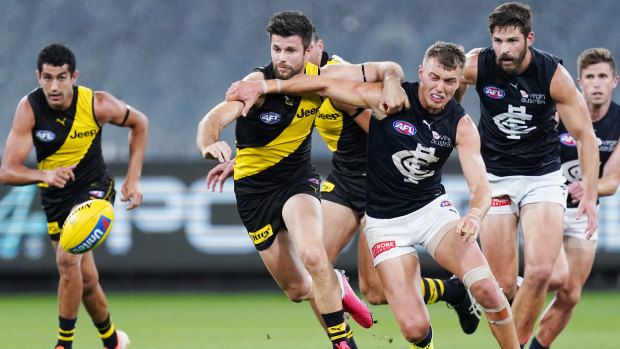 Back in the beginning: Carlton captain Patrick Cripps heads for the loose ball against Richmond's Trent Cotchin during the opening match of season 2020 at the MCG. 