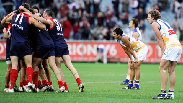 Melbourne players celebrate after the game.
