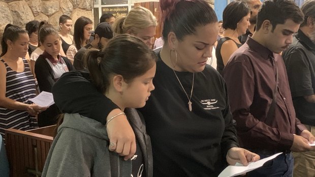 Attendees at a vigil for the victims of the Darwin shooting.