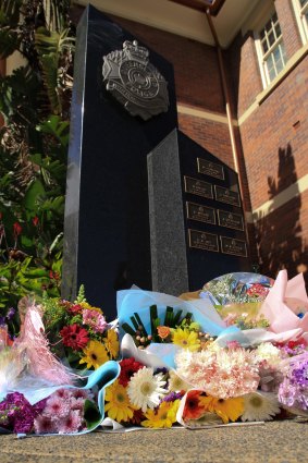 Flowers are left as a memorial for slain officer Senior Constable Brett Forte at Toowoomba police station.