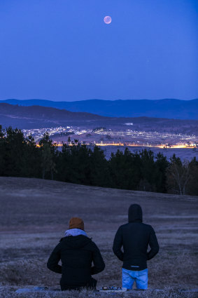 Spectators watch the lunar eclipse from the National Arboretum.