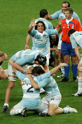 Agustin Pichot, rear center, reacts as Arocena, foreground center, Patricio Albacete, left, and Juan Martin Hernandez embrace each other, after Argentina defeated France 17-12 in the 2007 Rugby World Cup.