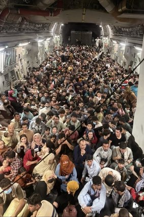 Afghan citizens are evacuated by the US Air Force from Hamid Karzai International Airport in Kabul.