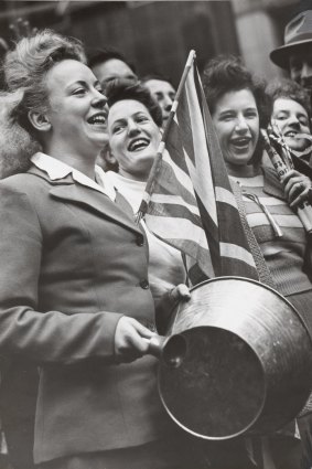 Women banging pails and ringing bells in Melbourne to celebrate victory in Europe.