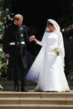 Meghan Markle and Britain's Prince Harry walk down the steps of St George's Chapel at Windsor Castle in Windsor, near London, England, following their wedding in May 2018.