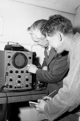Officers at the CSIRO listen to the radio signals of Russian satellite, Sputnik I, at Sydney University, 8 October 1957. 