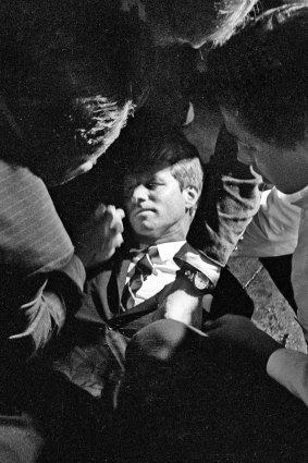 Hotel busboy Juan Romero (right) comes to the aid of Senator Robert F. Kennedy, as he lies on the floor of the Ambassador hotel in Los Angeles moments after he was shot.