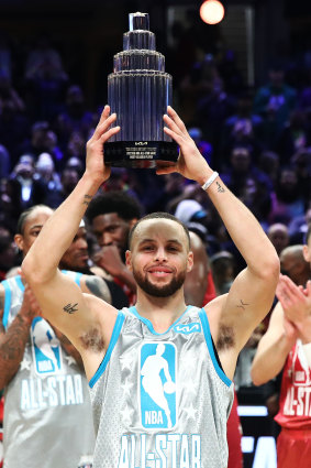 Curry holds the Kobe Bryant Trophy after being named MVP.