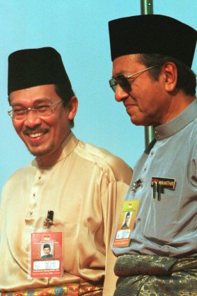 Anwar Ibrahim, left, stands next to Malaysian Prime Minister Mahathir Mohamad in 1998.