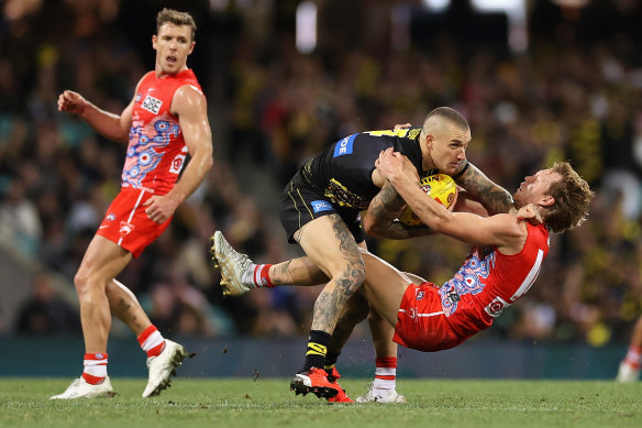 Dustin Martin is tackled by Callum Mills.