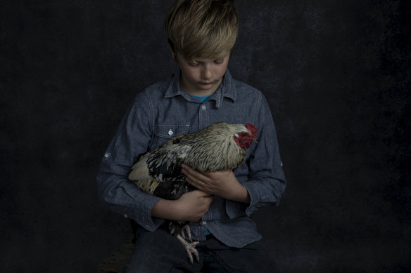 Tom holding one of his prized chickens. 