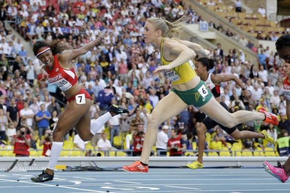 United States' Brianna Rollins, left, gold, and Australia's Sally Pearson, silver, cross the finish line in the women's 100m hurdles final at the Moscow world championships in 2013.