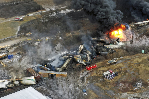 taken with a drone shows portions of a Norfolk Southern freight train that derailed Friday night in East Palestine, Ohio are still on fire the day after the derailment.