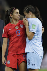 The United States' Alex Morgan comforts Thailand's Miranda Nild after the match.