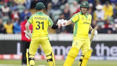 Leading lights: Warner congratulates Australian Aaron Finch after the Australian captain reached 50.