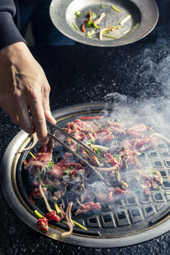 Cooking the beef on the grill.