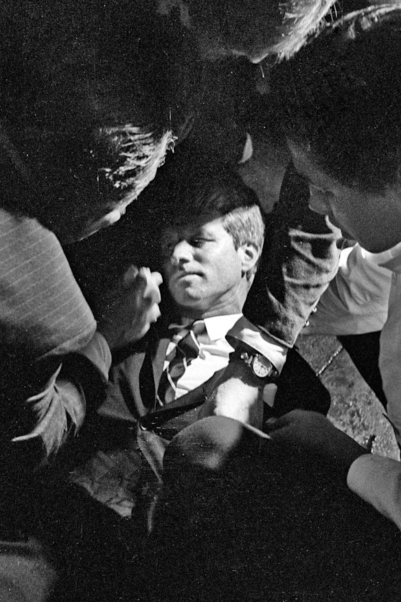 Hotel busboy Juan Romero (right) comes to the aid of Senator Robert F. Kennedy, as he lies on the floor of the Ambassador hotel in Los Angeles moments after he was shot.