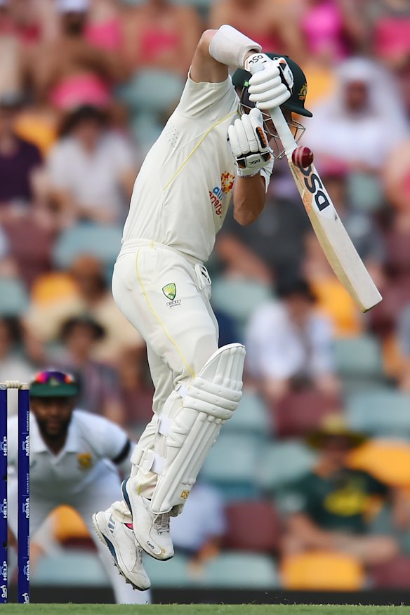 David Warner fends the first ball of the Australian innings to Khaya Zondo at short leg.